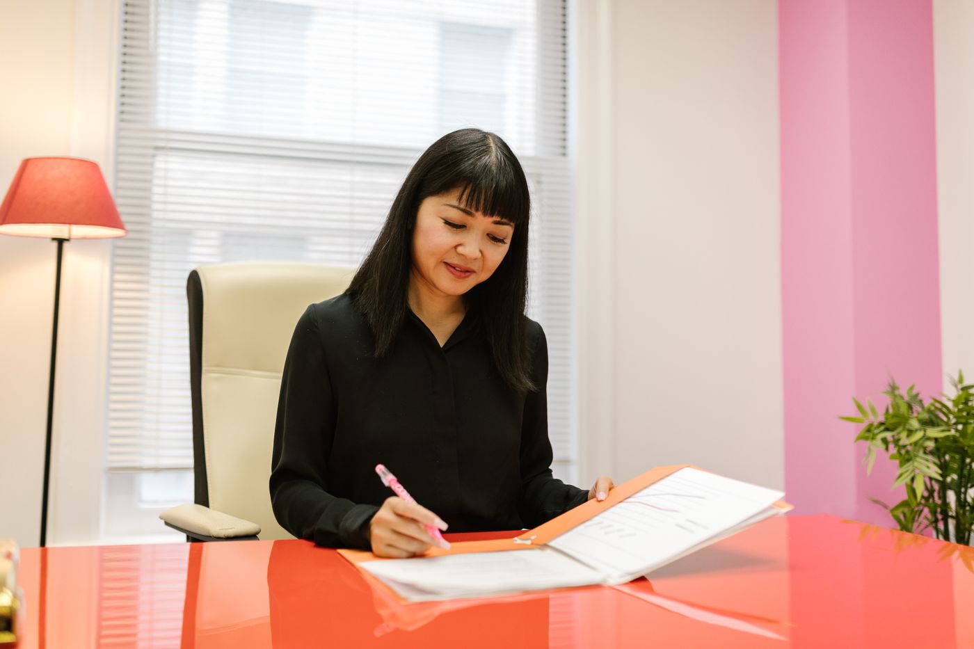An officer reviewing and signing documents at a desk