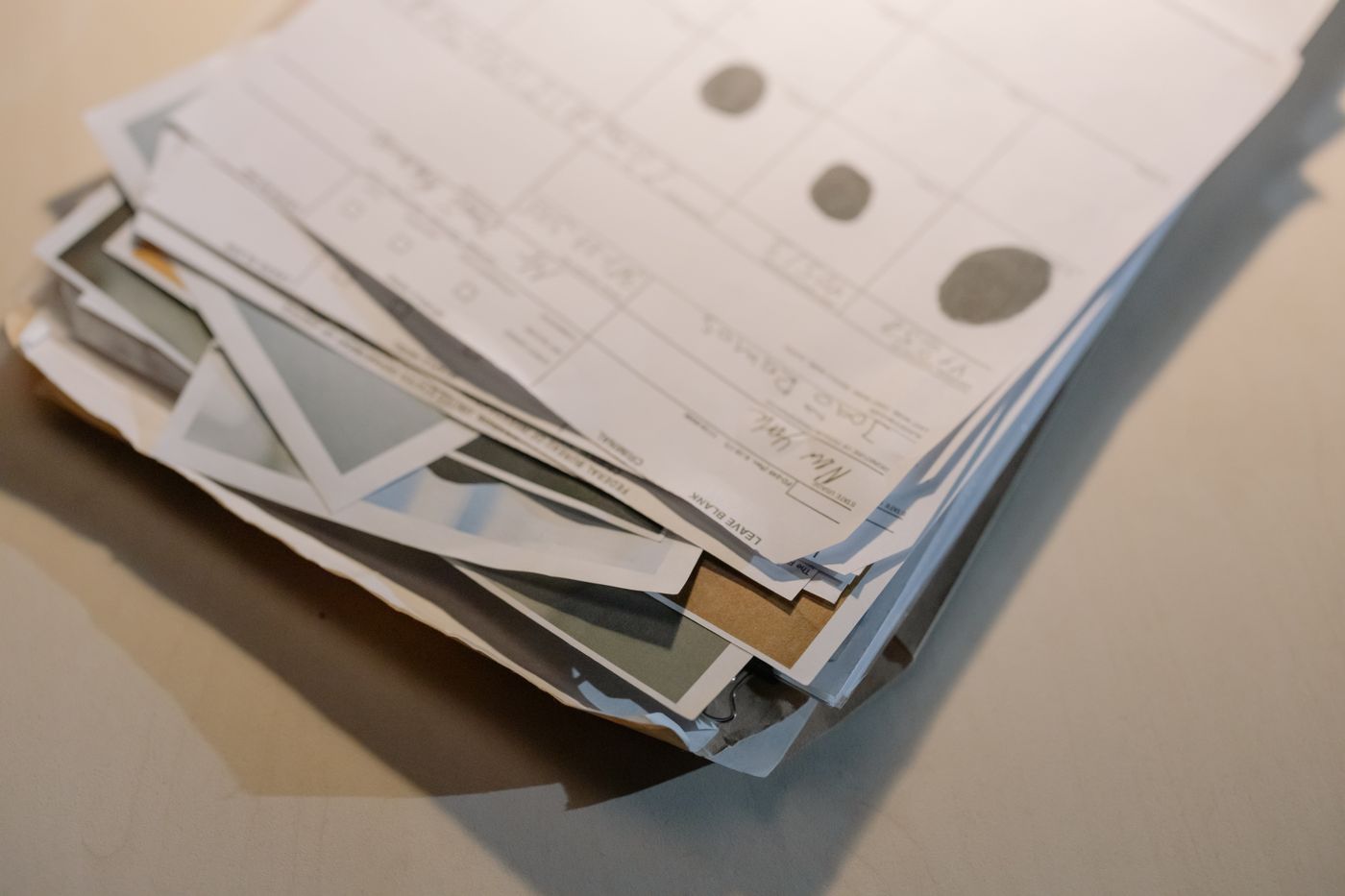A stack of application papers on a desk