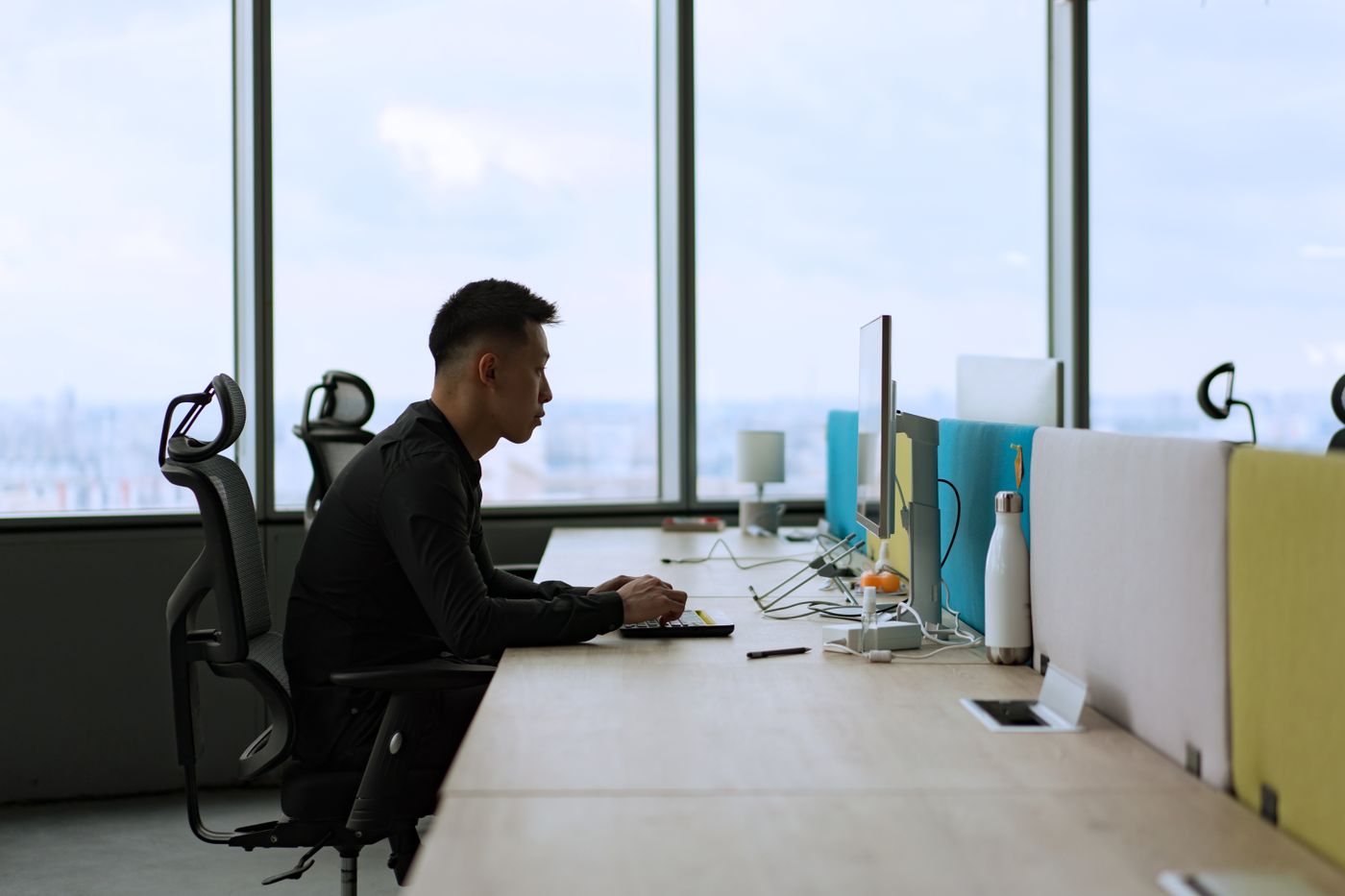 An officer working at a desk computer in an office