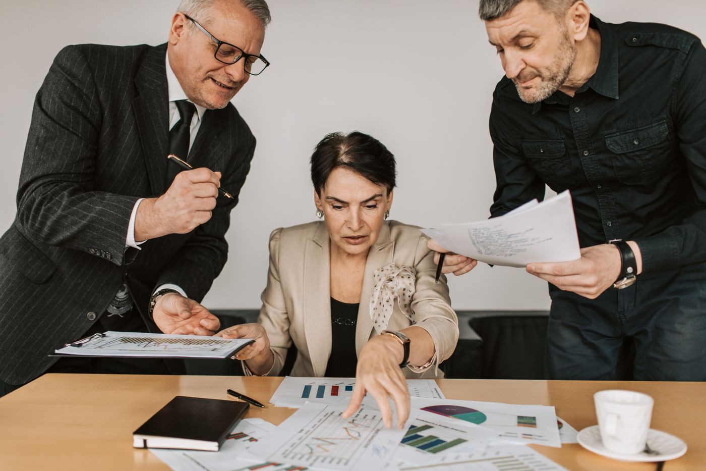 Three colleagues reviewing a report together at a table
