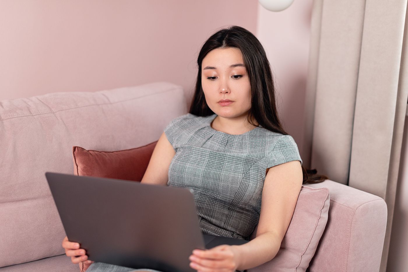 An applicant filling in a form on a laptop at home