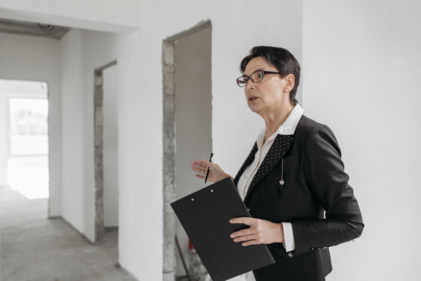 An inspector with a clipboard checking a premises